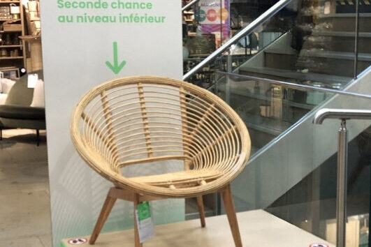 Intérieur d'un magasin de meubles avec estrade sur laquelle est posé un fauteuil d'occasion par Emilie Miquelestorena consultante merchandising Another retail